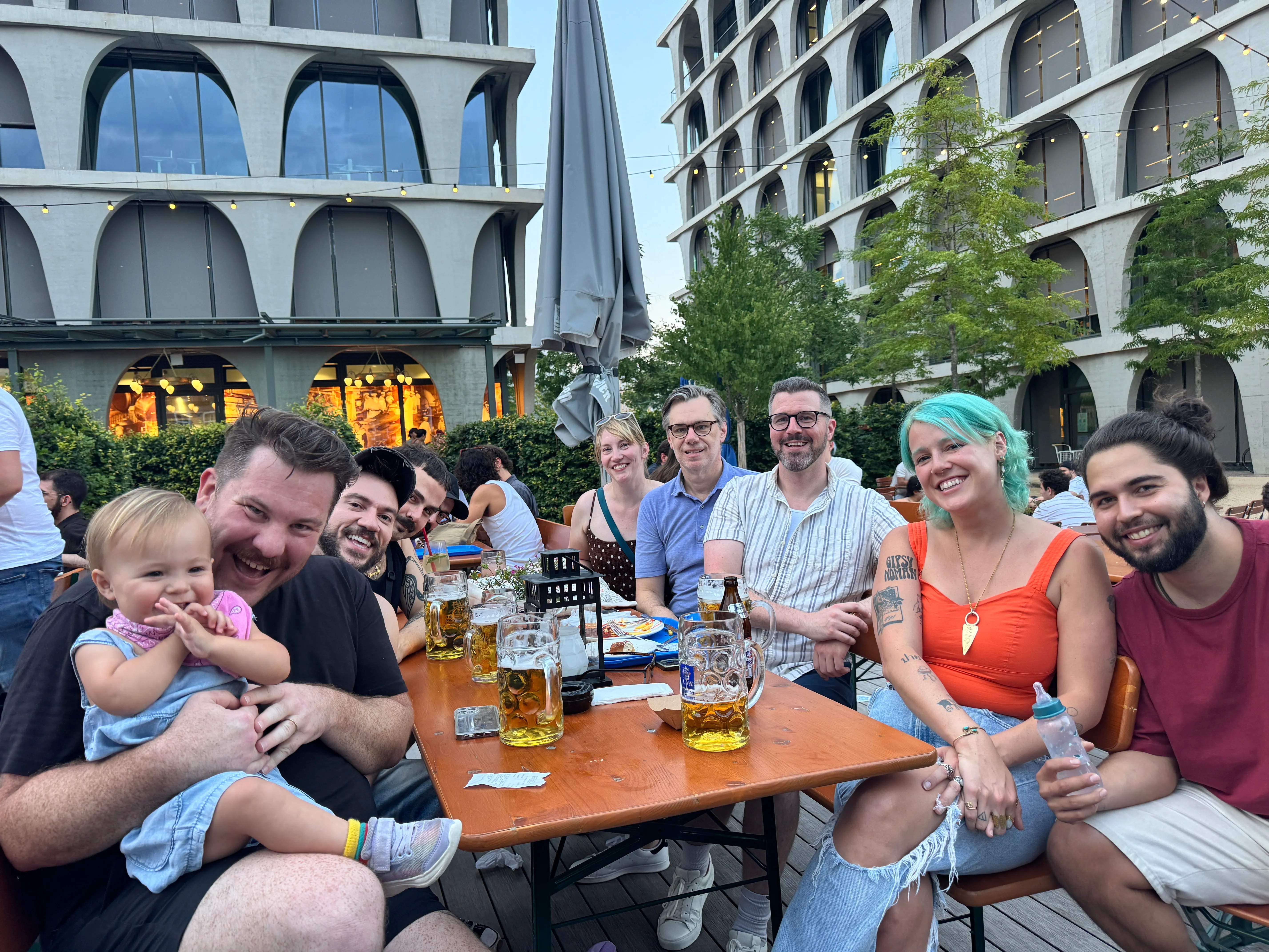 Perry Street Software team members gathered outdoors with a child