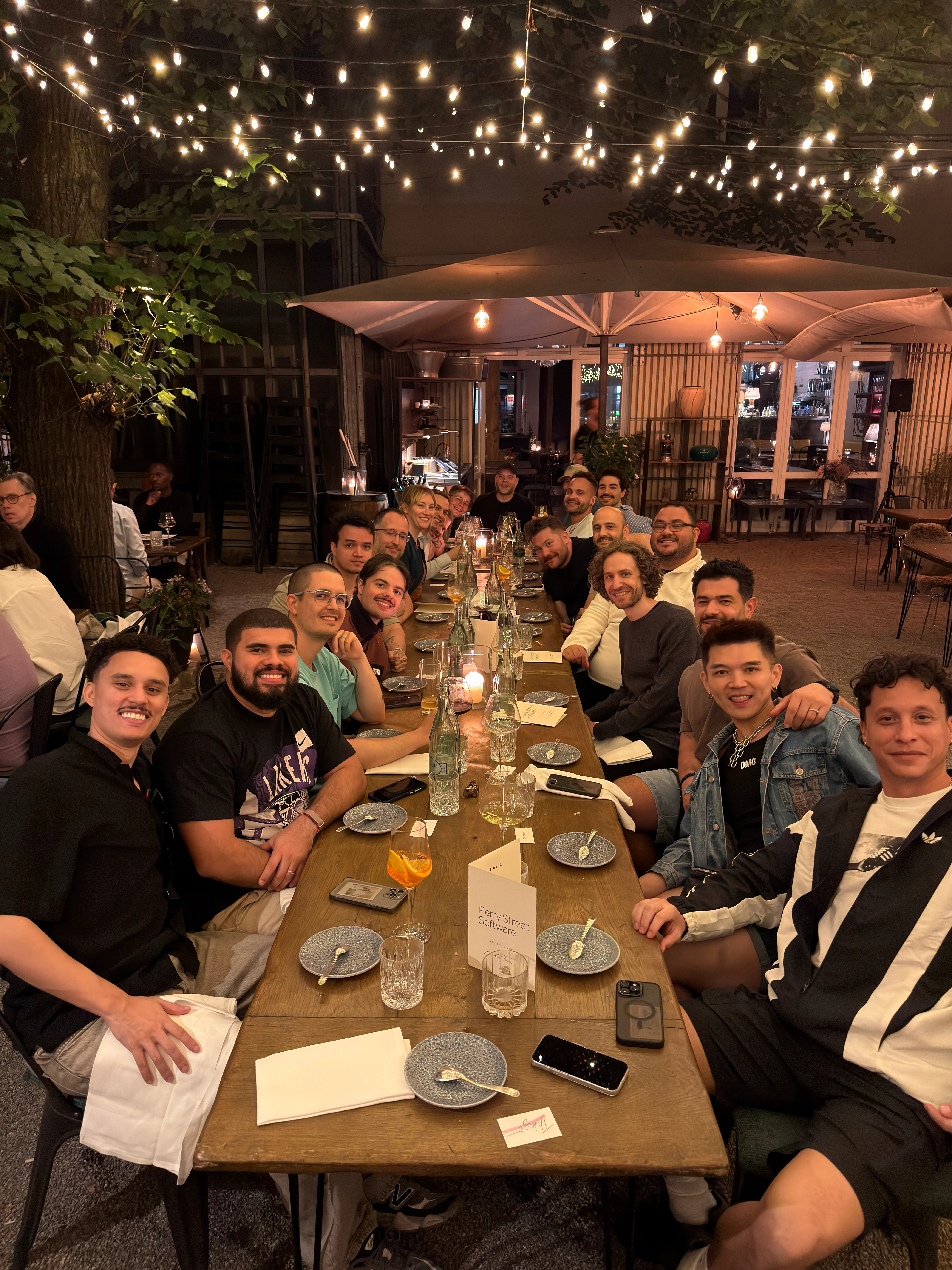 Perry Street Software team members gathered around an outdoor dinner table