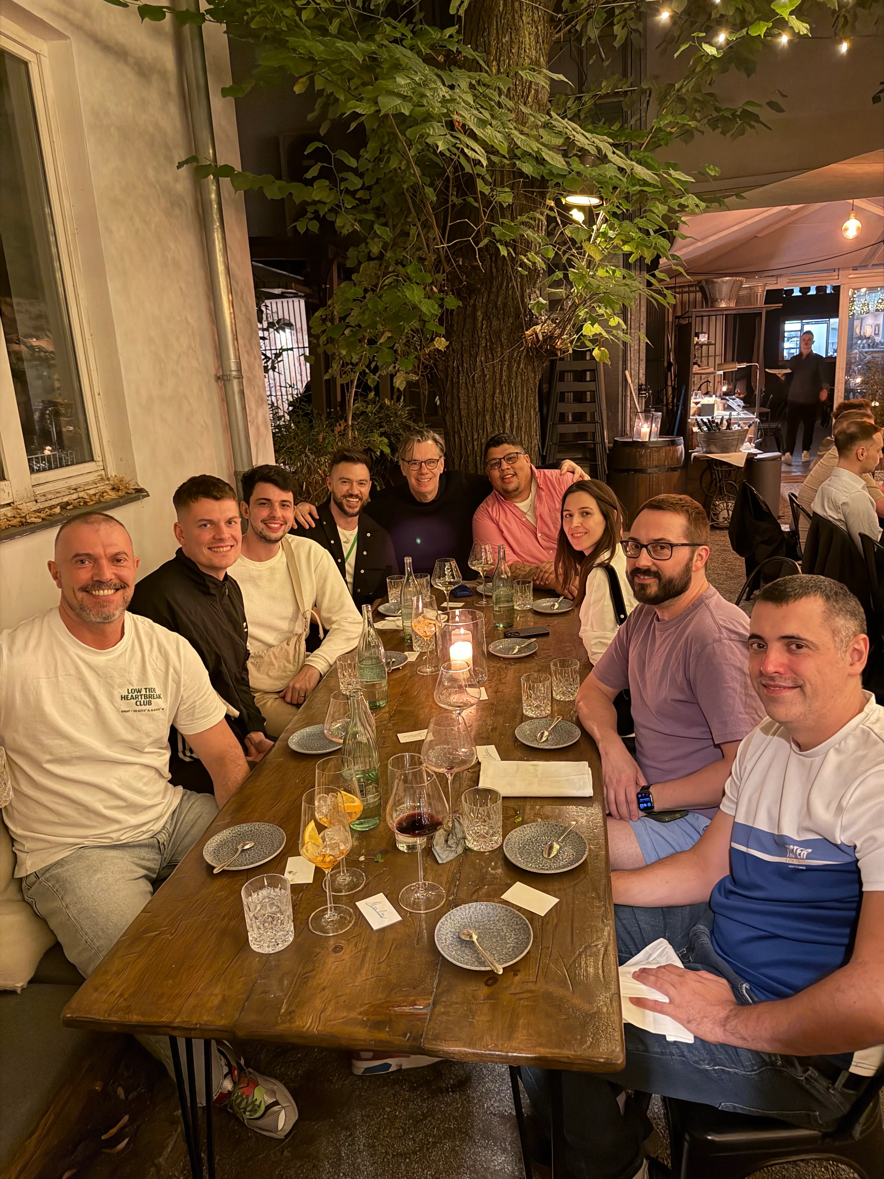 Perry Street Software team members enjoying dinner outdoors under string lights