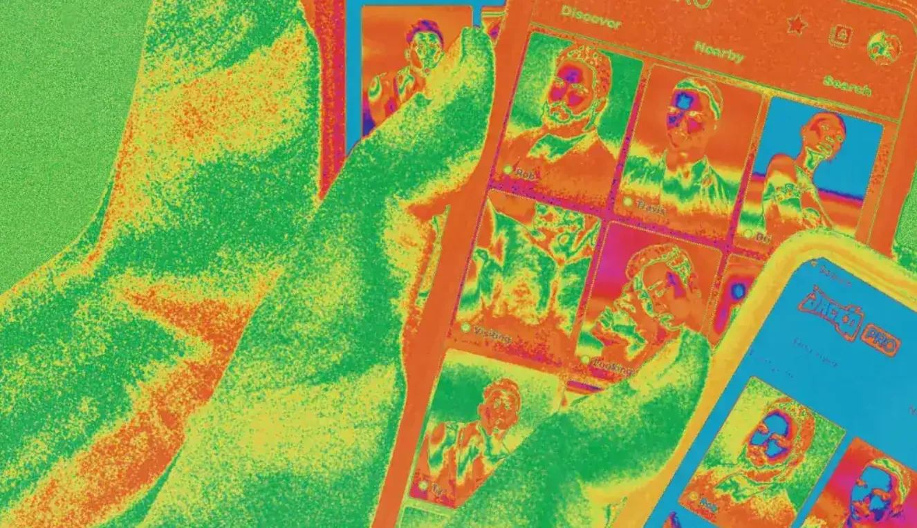 Thermal-imaging view of a hand holding phones running the Jack’d app