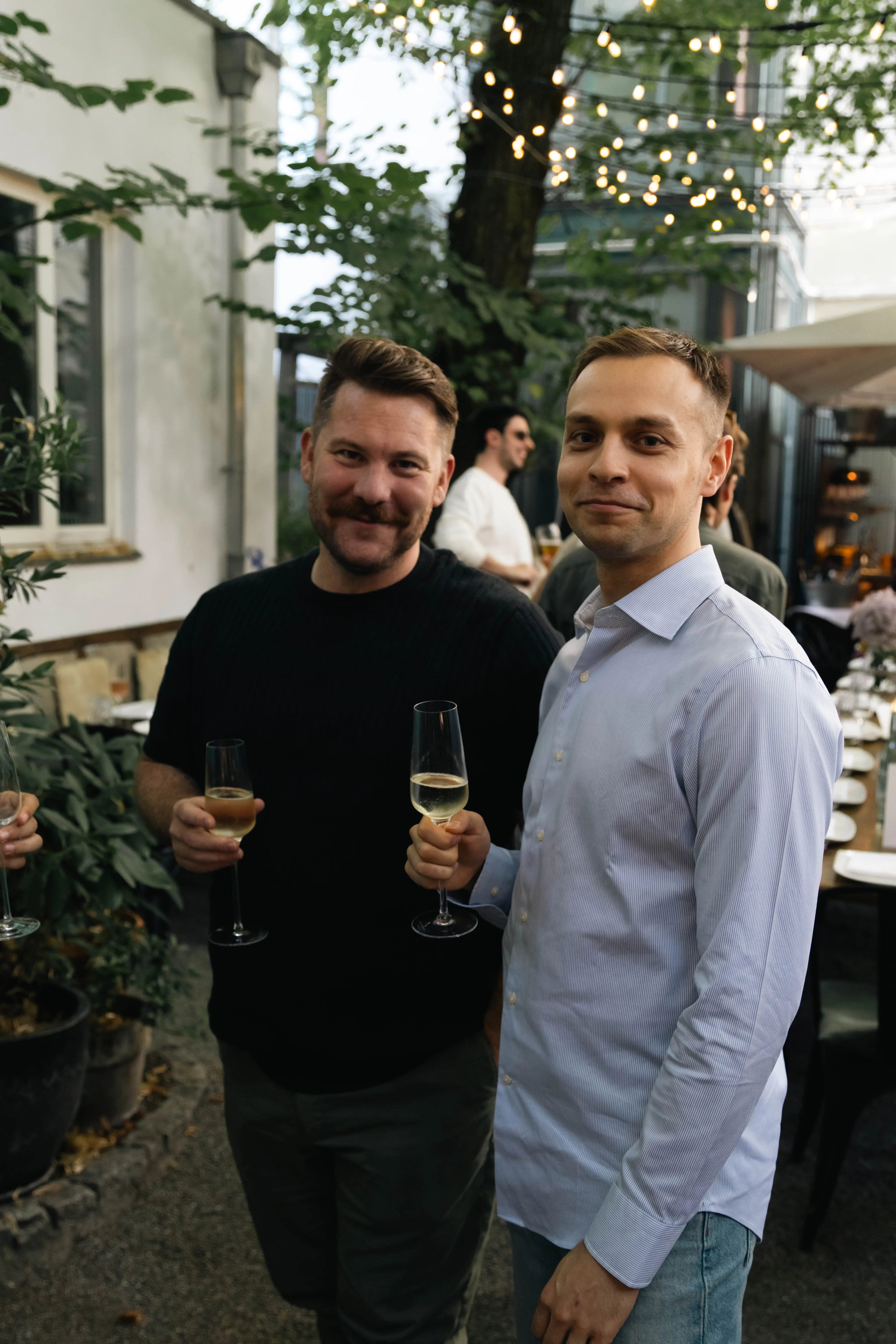 Two Perry Street Software team members smiling with drinks