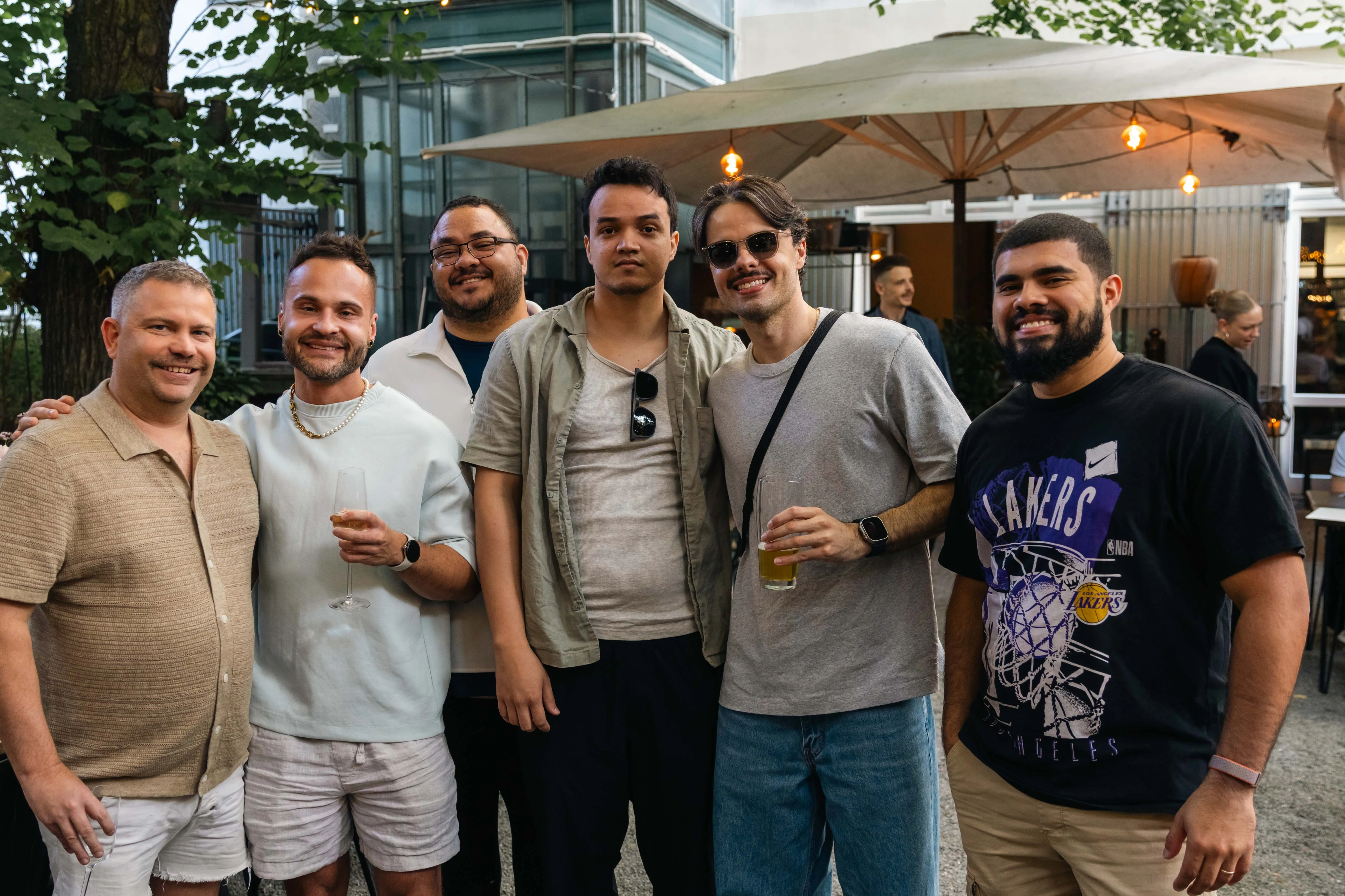 Perry Street Software team members smiling under patio lights