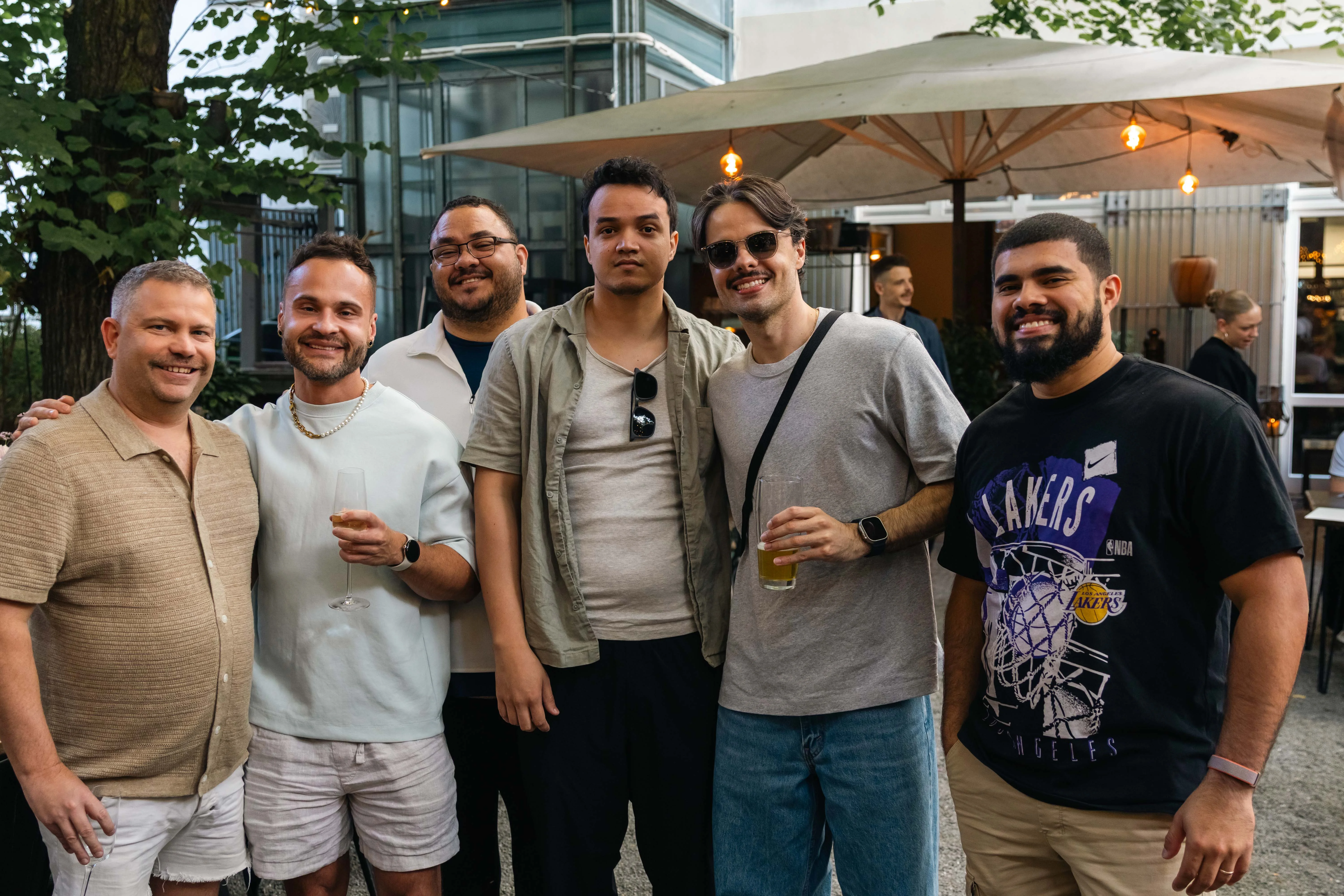 Perry Street Software team members smiling under patio lights